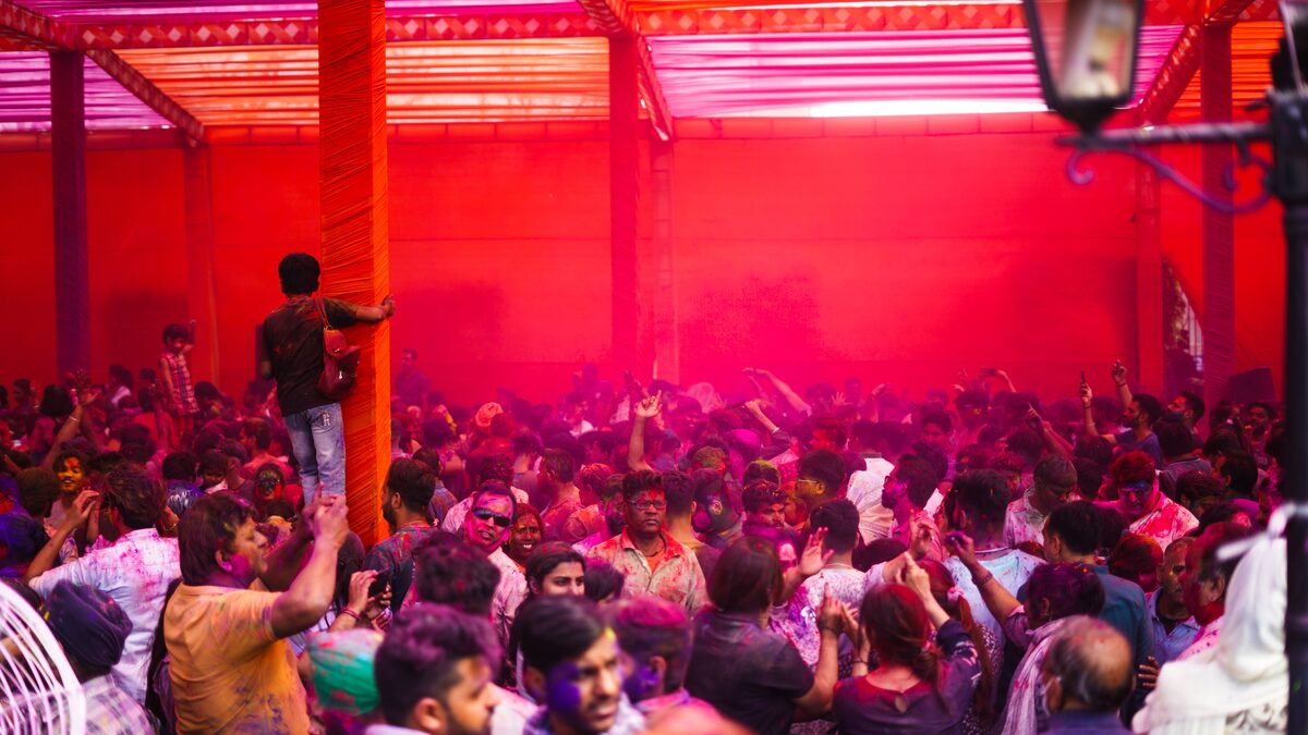 A colorful stage lit for a dance number with warm gold and red tones