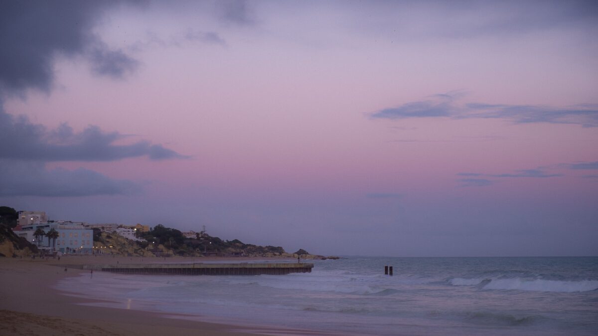 Serene retro-tinted beach at sunset evoking a nostalgic summer mood