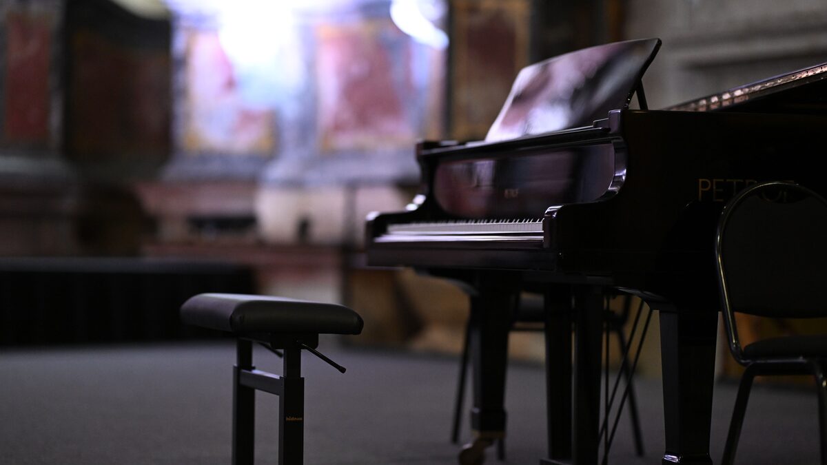 Sheet music on a grand piano in warm light