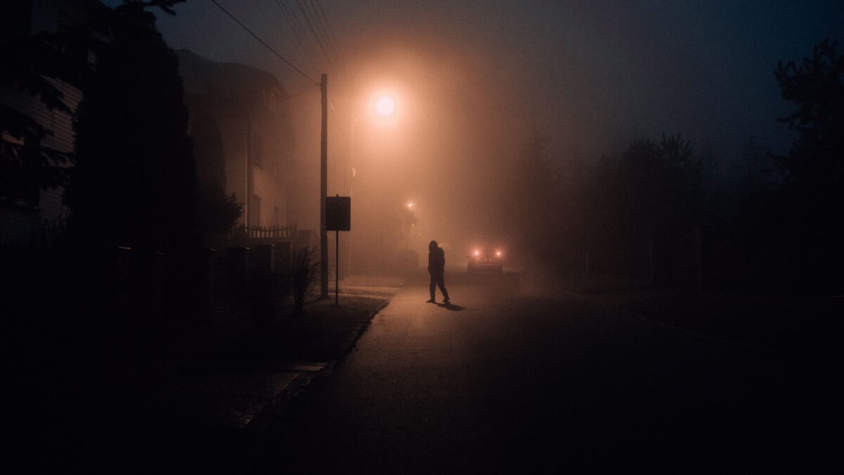 a lone silhouette in fog, dark moody atmosphere