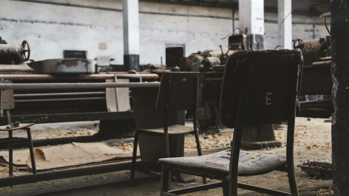 Gritty abandoned factory with heavy machinery evoking a harsh mechanical mood