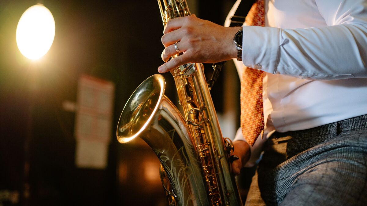Dim jazz club with a piano and an upright bass under warm light