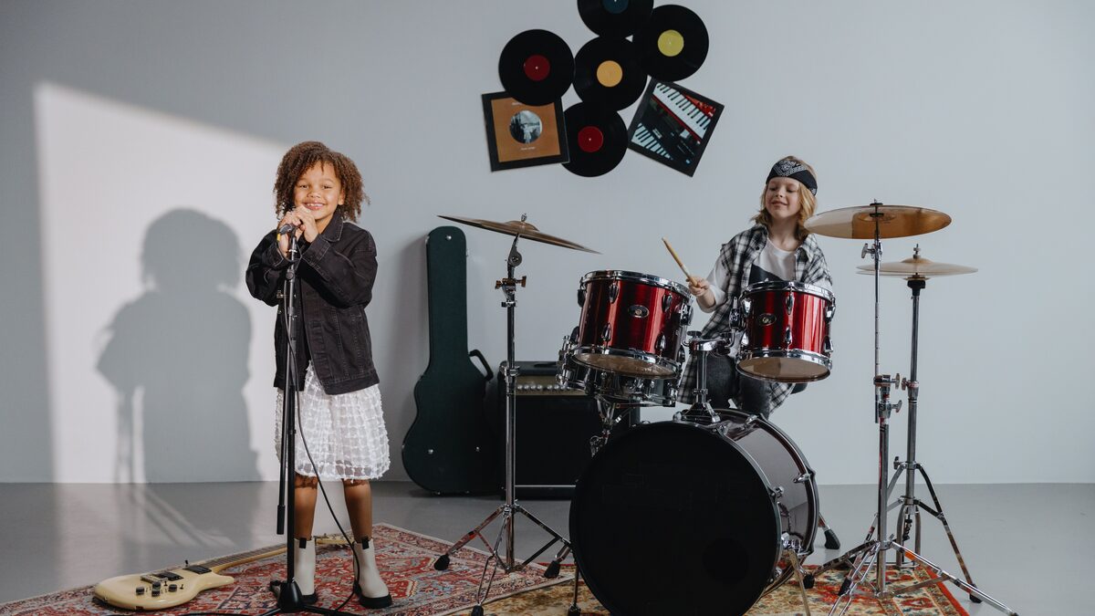 Young child clapping and smiling along to music at home