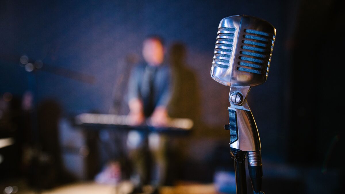 A vintage recording studio with a mixing console and microphone
