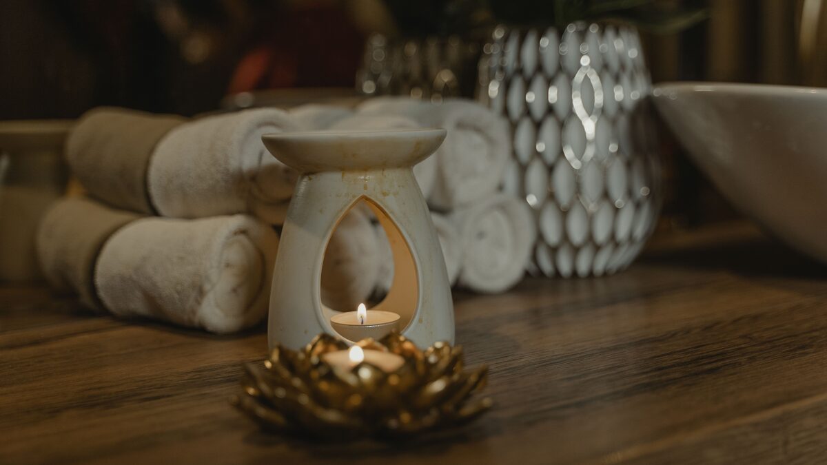 a serene spa setting with a lit candle and stones
