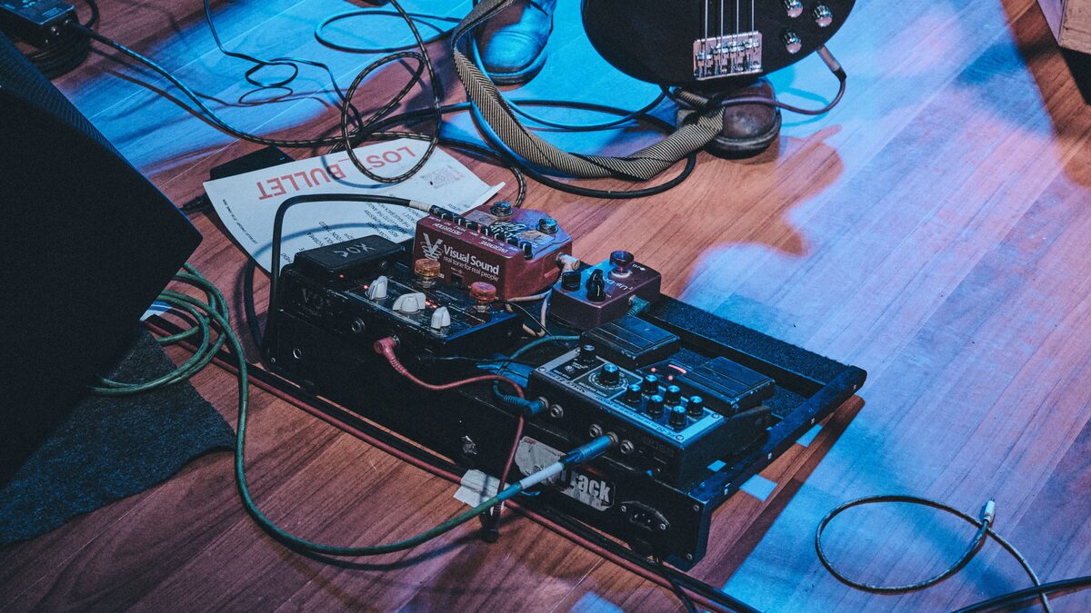 A music producer trimming a short audio clip on a laptop timeline