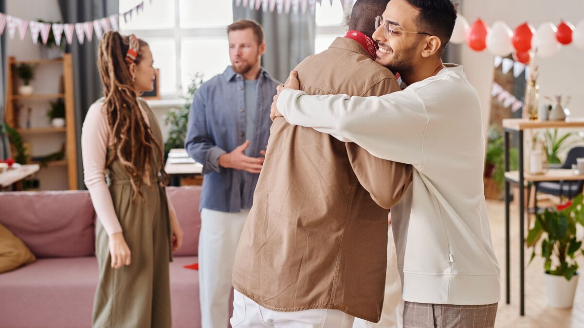 A large group of people embracing at a reunion gathering