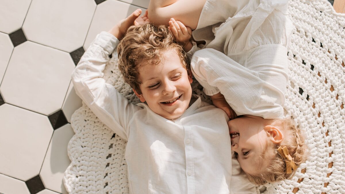 Two brothers laughing together with arms around each other's shoulders