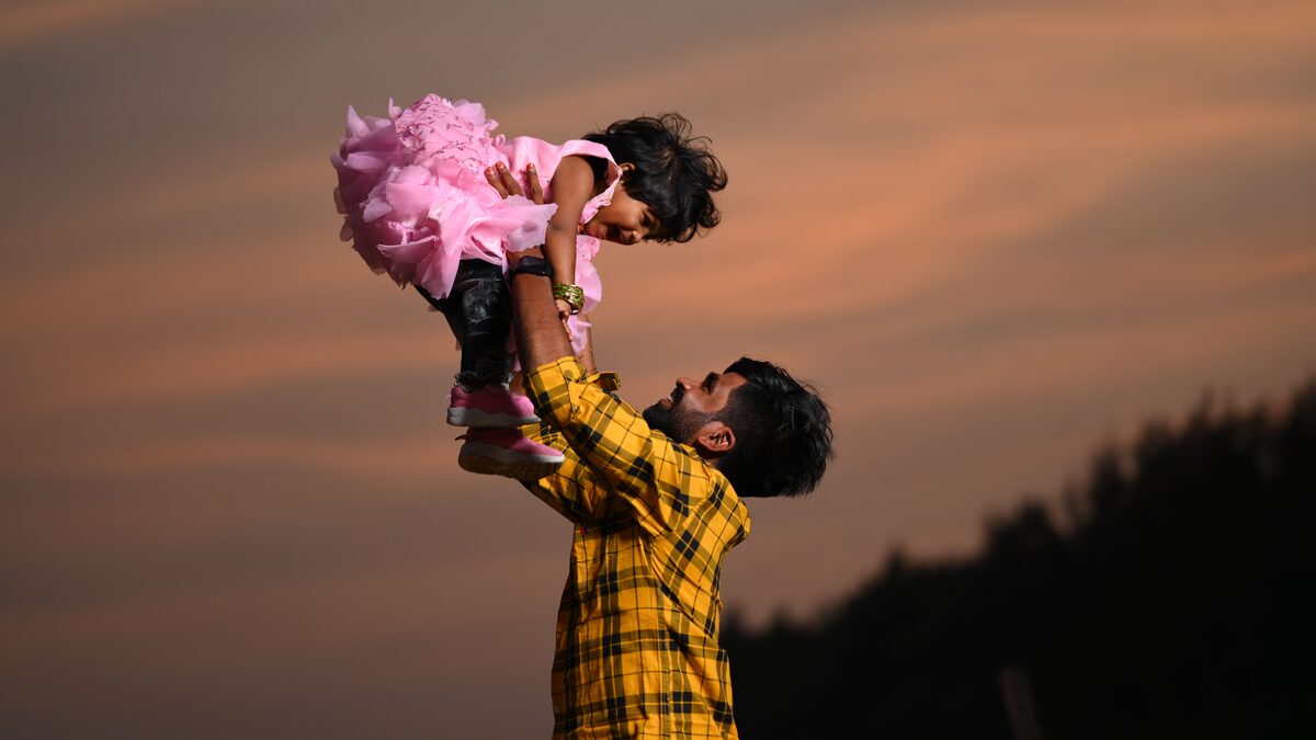 Father and adult child laughing together, the feeling behind an AI song for dad