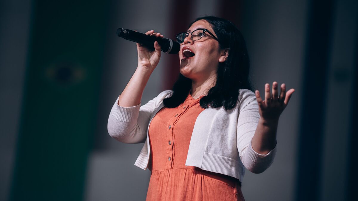 a singer performing passionately into a microphone