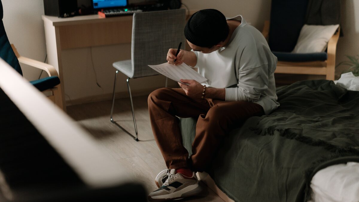 Songwriter in a home studio, reviewing the Beatoria AI music generator