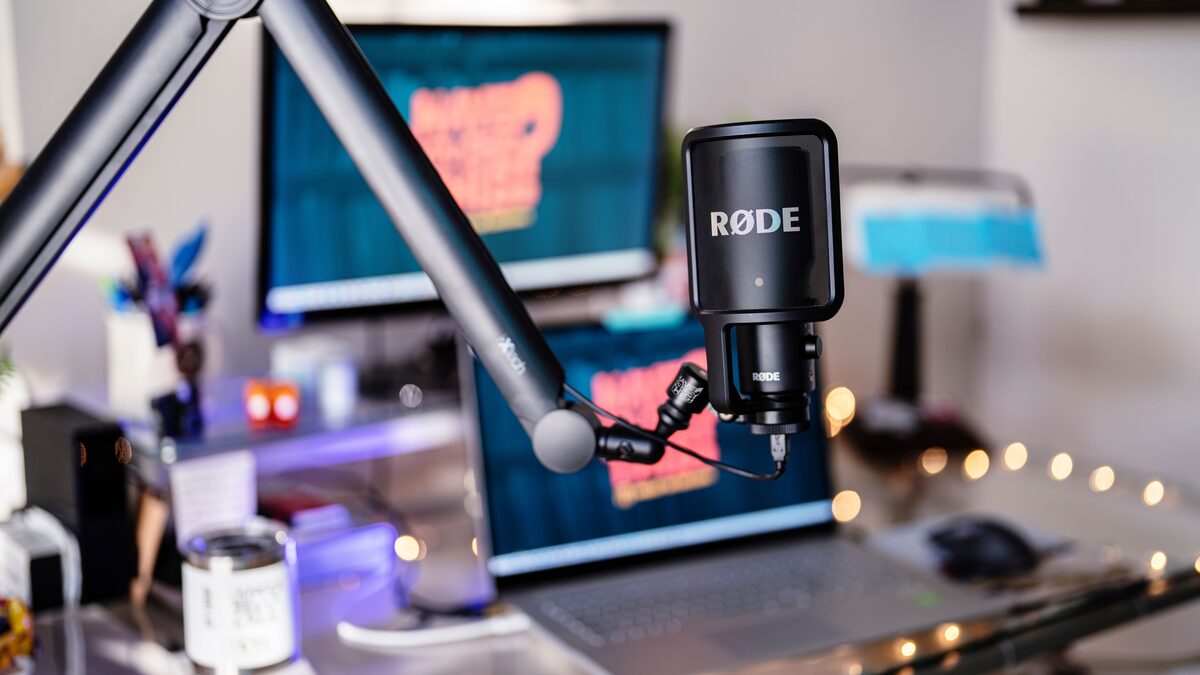 a modern podcast studio with a microphone and desk setup