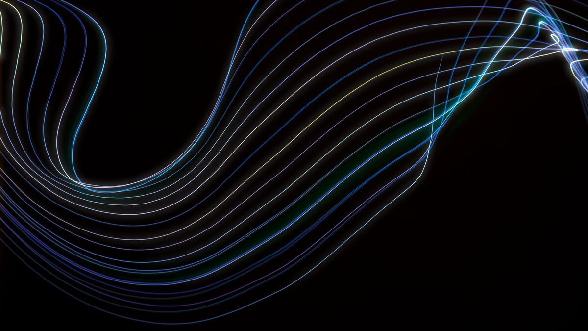 Abstract sound waves flowing out of a text cursor on a dark screen