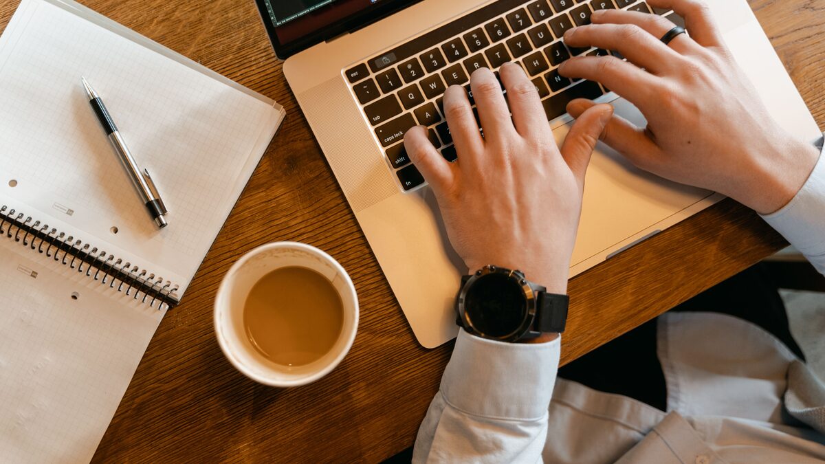 Writing on a laptop, representing how to write Suno prompts
