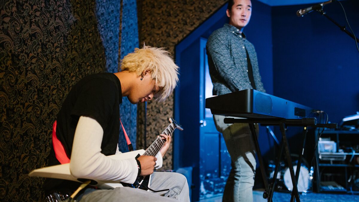 Musicians playing guitar, representing making an instrumental in Suno