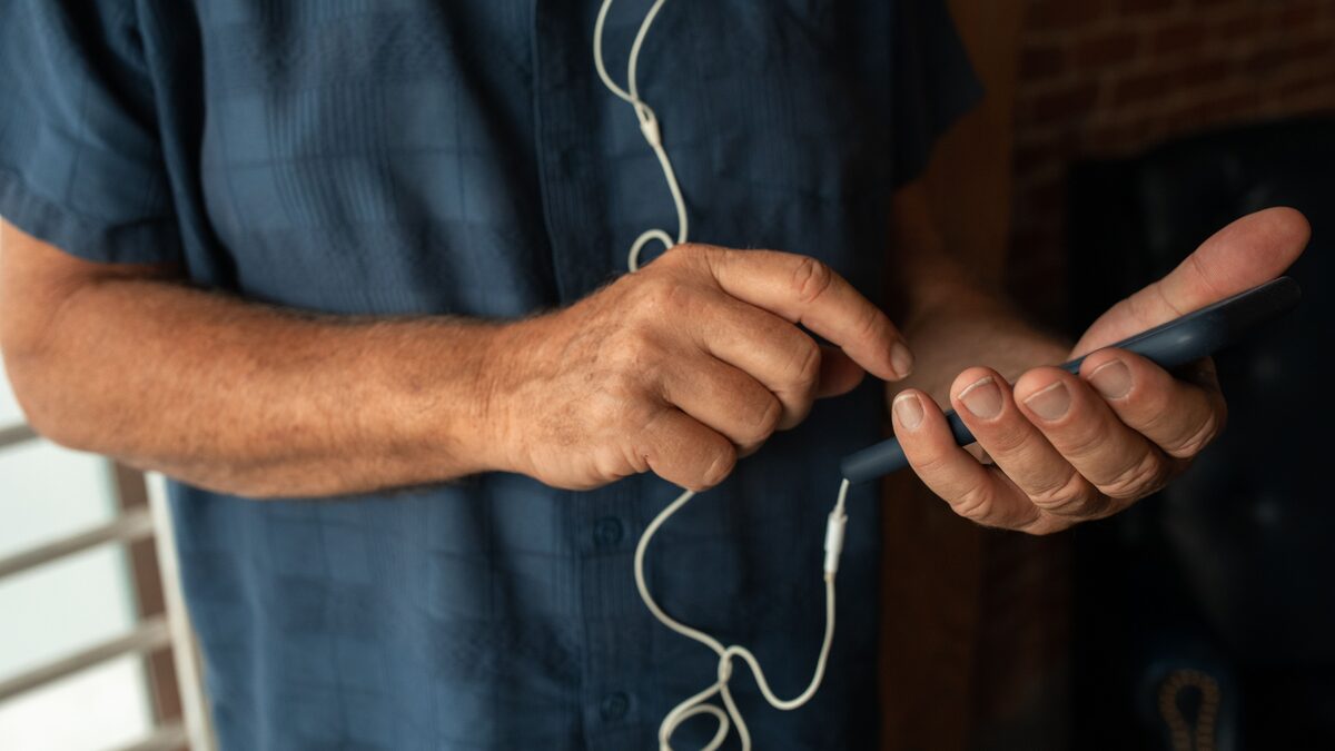 Person using a smartphone, setting a custom AI ringtone